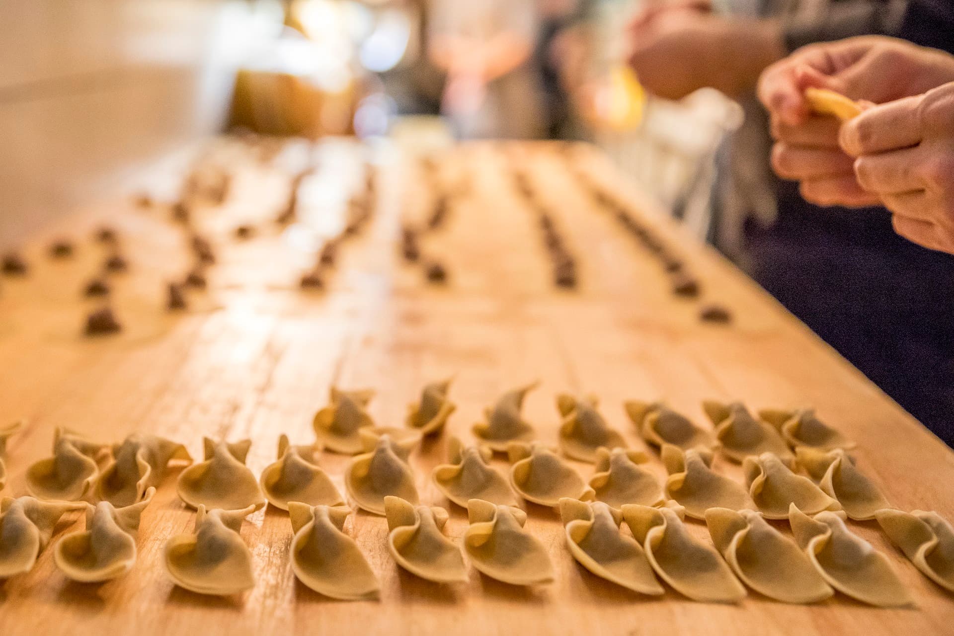 Housemade pasta being formed by hand